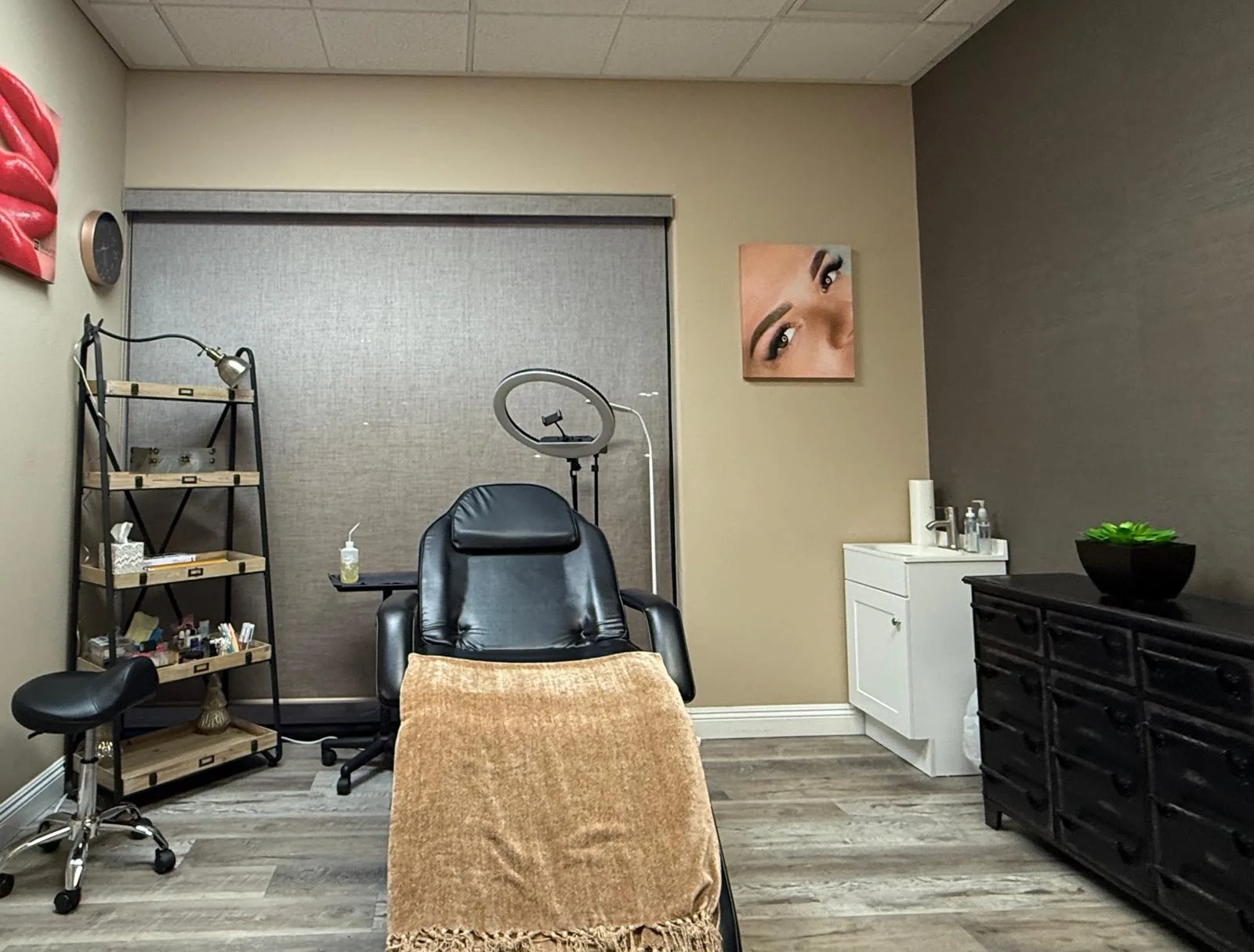 Private treatment room at MB Beauty with a reclining chair, ring light and supply shelves