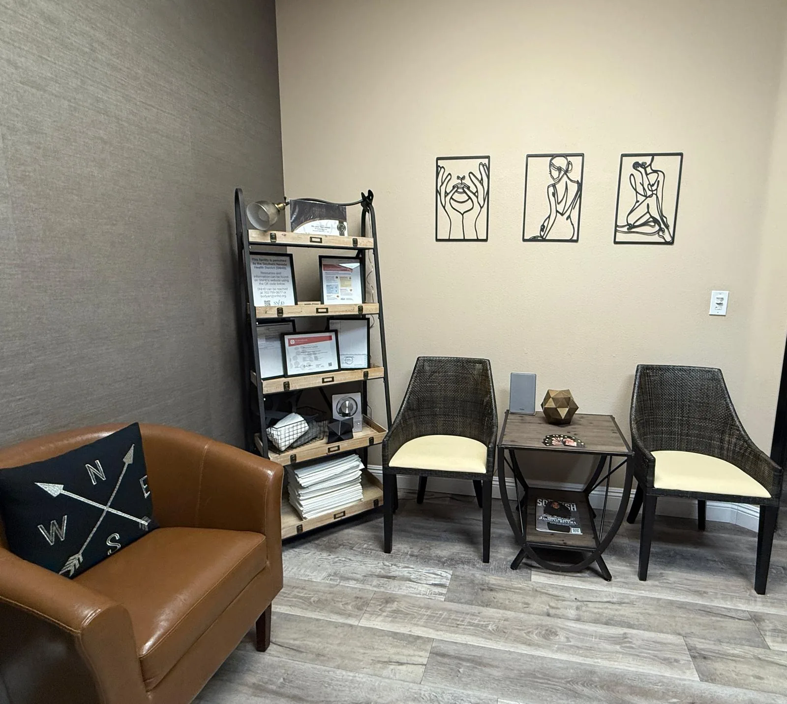 Waiting area at MB Beauty with a leather sofa, two chairs and line-art prints